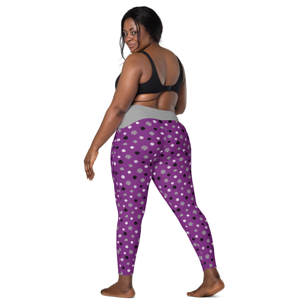 back view of dark-skinned female-presenting model looking over her shoulder. She is wearing the asexual dice leggings and a black sports bra