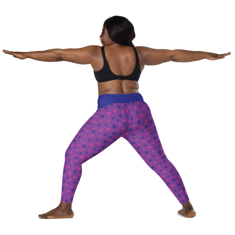 back view of dark-skinned female-presenting plus size model wearing the bisexual dnd dice leggings and a black sports bra. She is doing a warrior yoga pose with arms extended