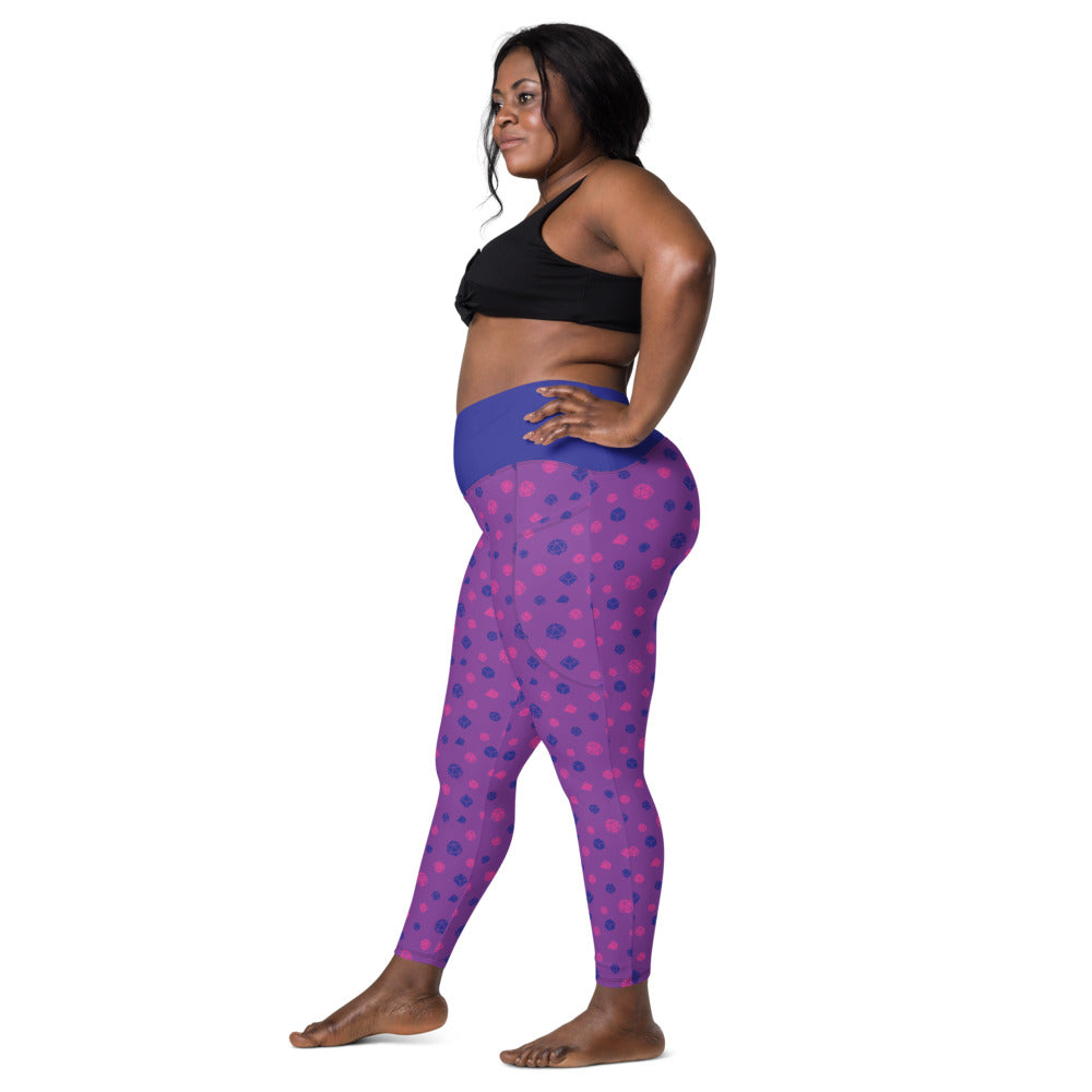 Left side view of dark-skinned female-presenting model wearing the bisexual dice leggings and black sports bra. She is facing left with her left hand on her hip and right leg forward