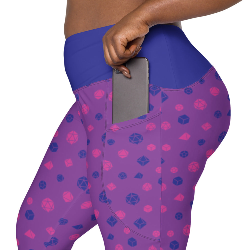 left side view of the bisexual dnd dice plus size leggings. the dark-skinned female-presenting model is sliding her phone into one of the side pockets