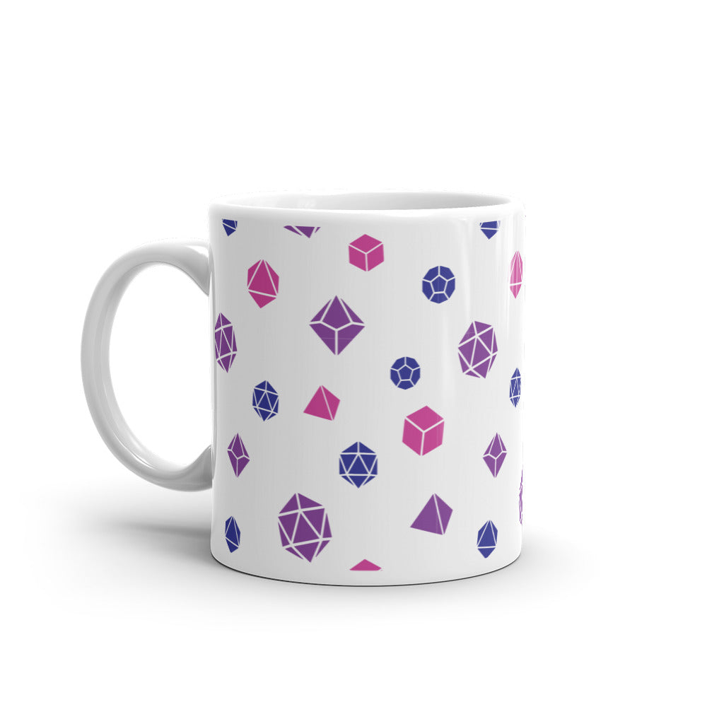 white mug on a white background with handle facing left. It has an all-over print of polyhedral d&d dice in the bisexual colors of purple, blue, and pink