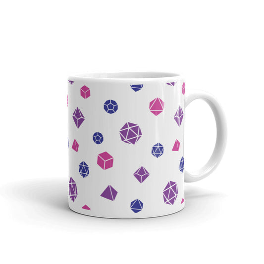 white mug on a white background with handle facing right. It has an all-over print of polyhedral d&d dice in the bisexual colors of purple, blue, and pink