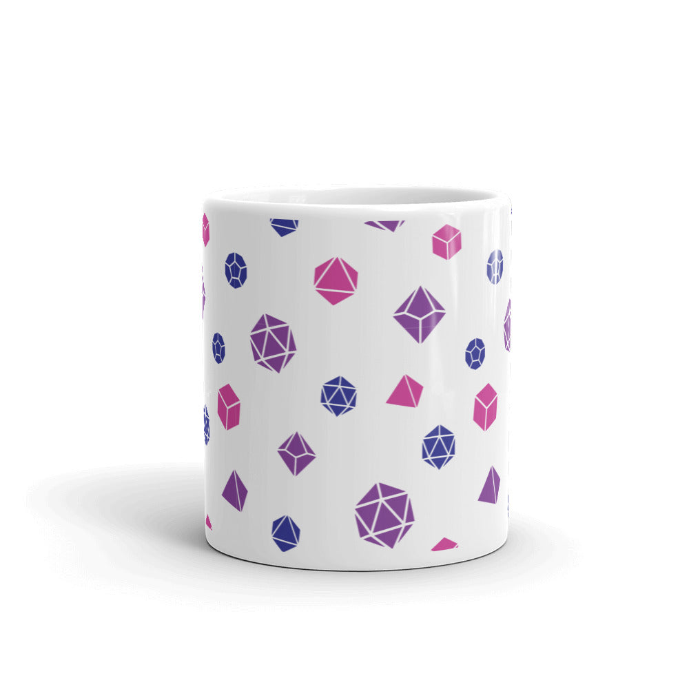 white mug on a white background with handle facing back. It has an all-over print of polyhedral d&d dice in the bisexual colors of pink, purple, and blue