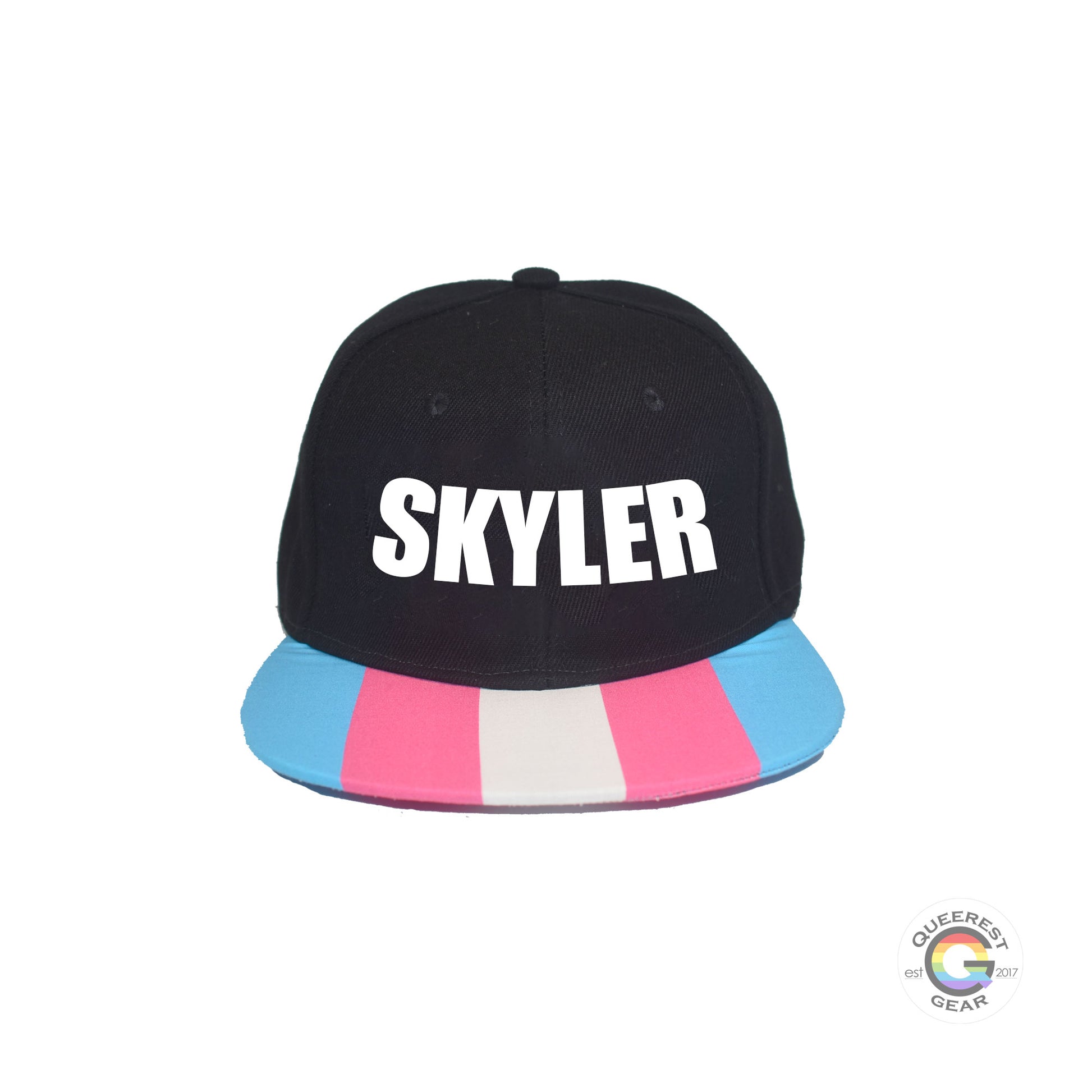 Custom black flat bill snapback hat. The brim has the transgender pride flag on both sides and the front of the hat has the name “skyler” in white. Front view