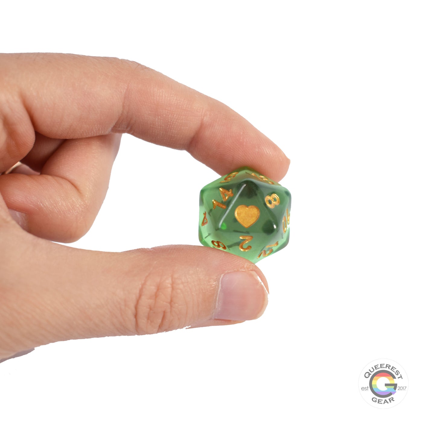 A hand holding up the d20 die to show off the heart, color, and transparency