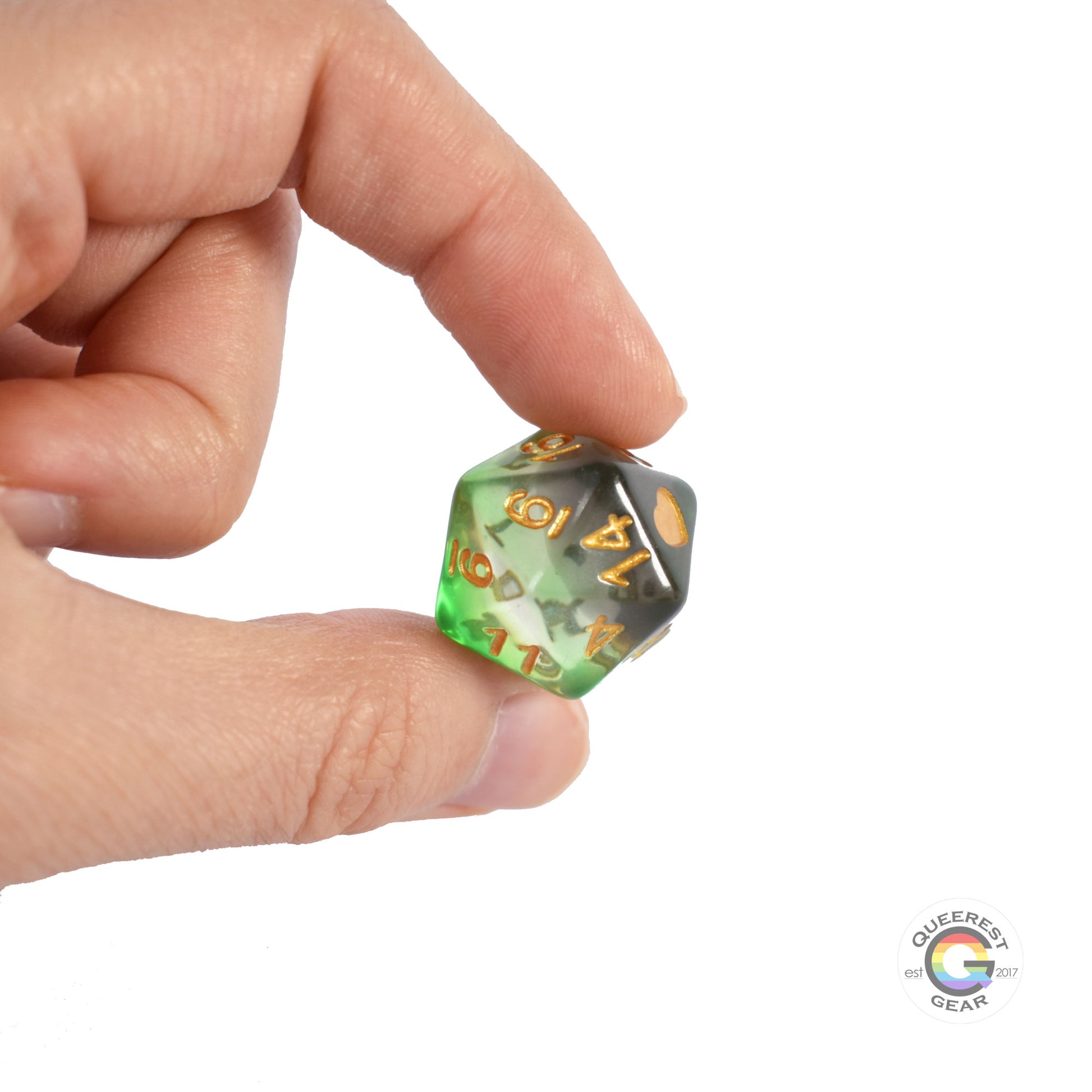 A hand holding up the d20 to show off the color and transparency