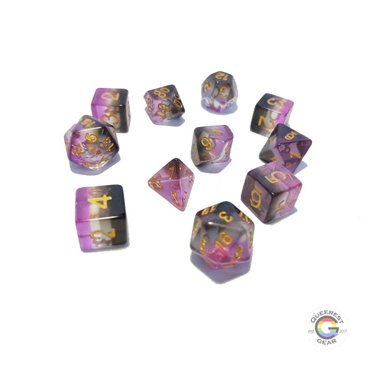 11 piece set of polyhedral dice scattered on a white background. They are transparent and colored in the stripes of the asexual flag with gold ink.