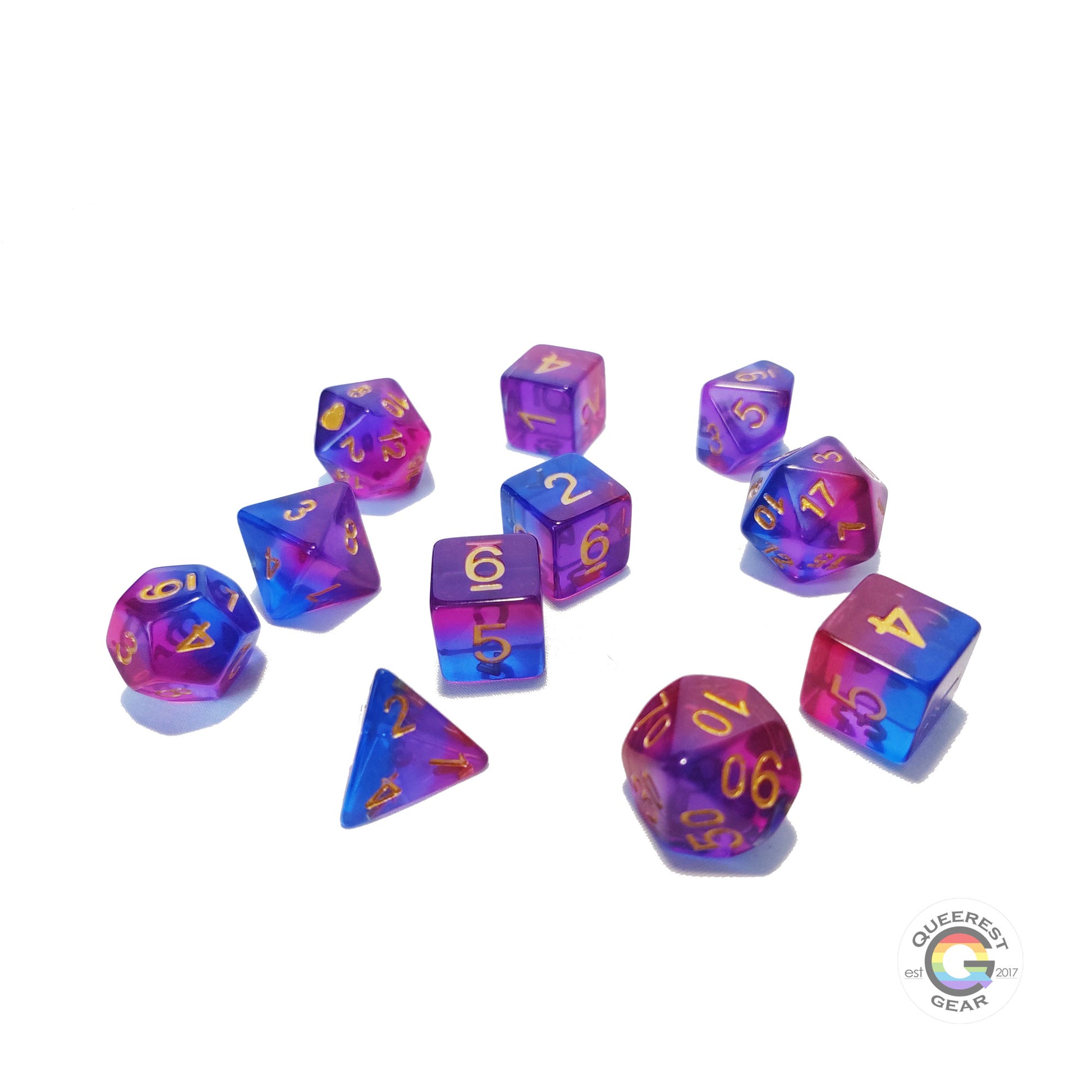 11 piece set of polyhedral dice scattered on a white background. They are transparent and colored in the stripes of the bisexual flag with gold ink.