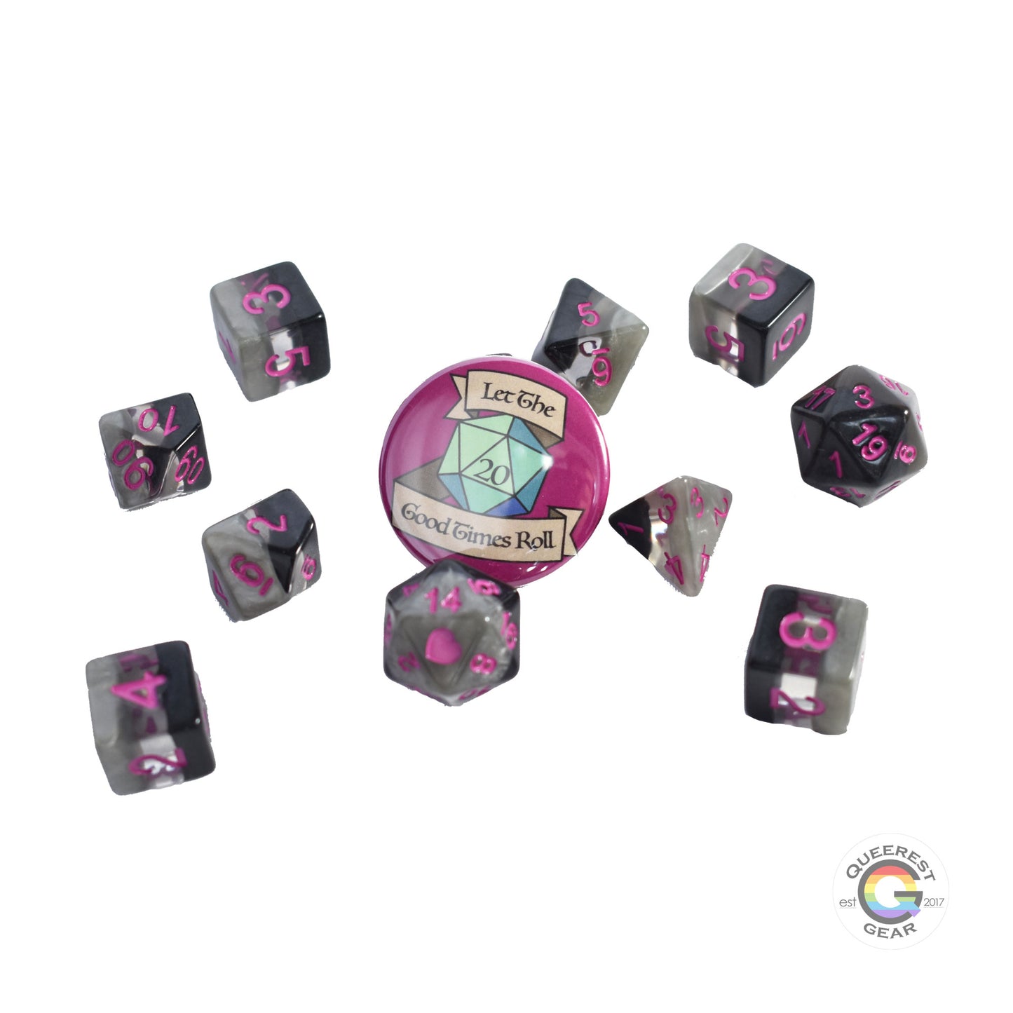 11 piece set of polyhedral dice scattered on a white background. They are transparent and colored in the stripes of the demisexual flag with magenta ink. There is the freebie “let the good times roll” pinback button among them. 