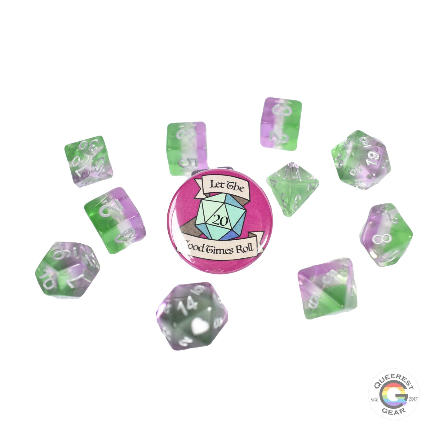 11 piece set of polyhedral dice scattered on a white background. They are transparent and colored in the stripes of the genderqueer flag with silver ink. There is the freebie “let the good times roll” pinback button among them. 