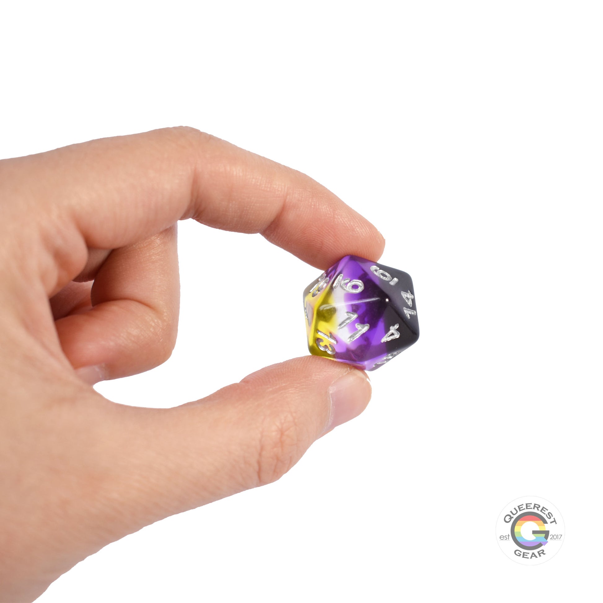 A hand holding up the nonbinary d20 to show off the color and transparency
