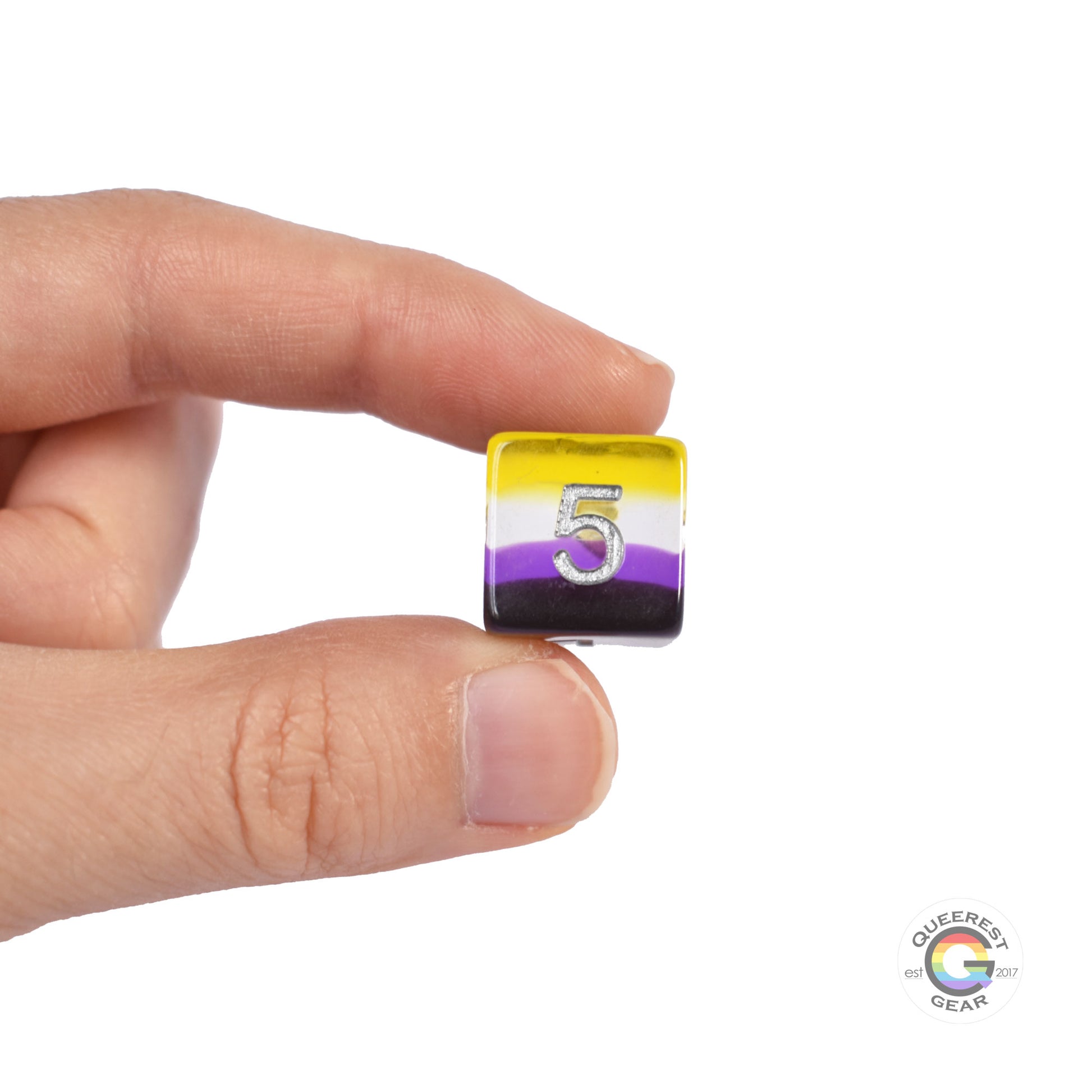 A hand holding up the nonbinary d6 to show off the color and transparency
