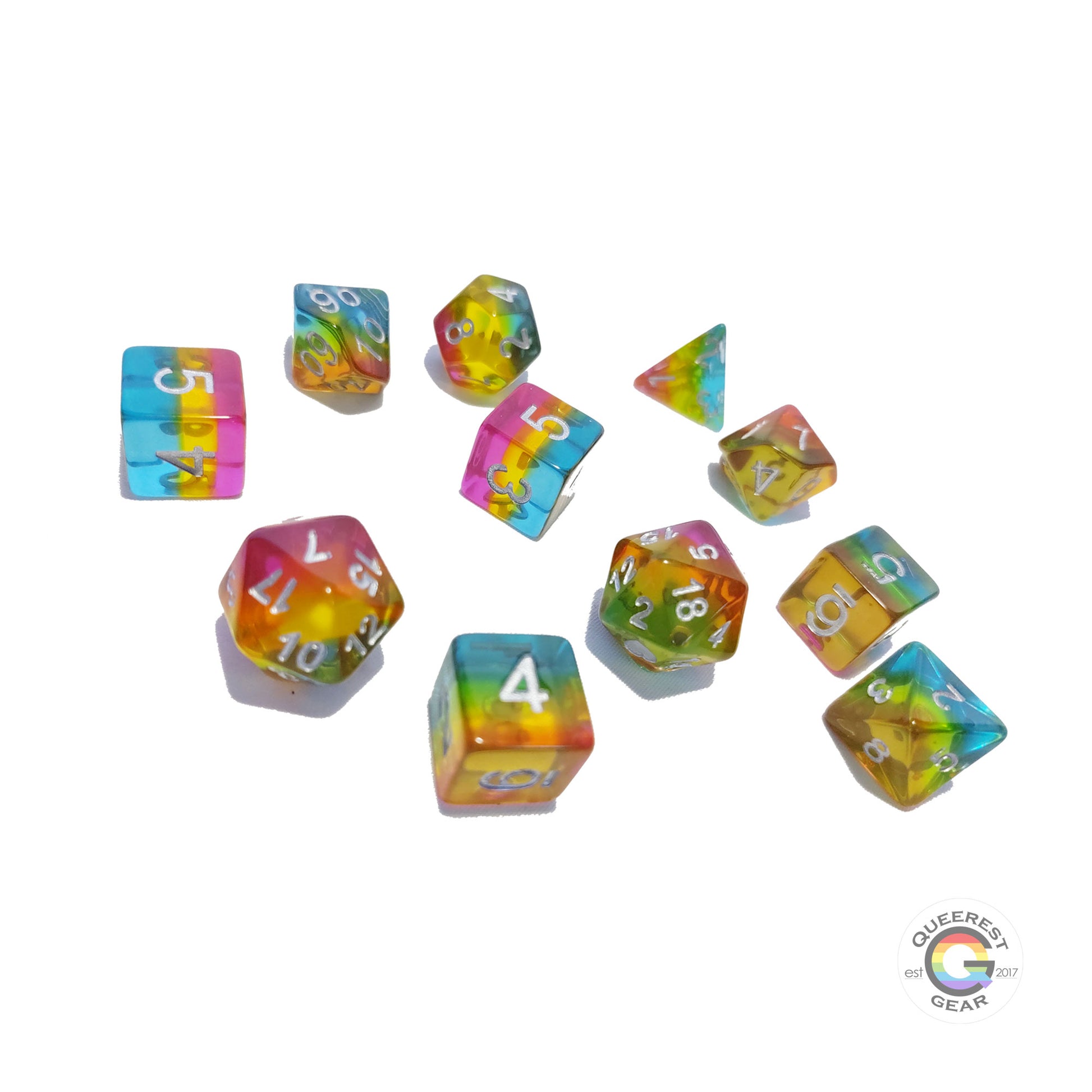 11 piece set of pansexual dice scattered on a white background. They are transparent and colored in the stripes of the nonbinary flag with silver ink