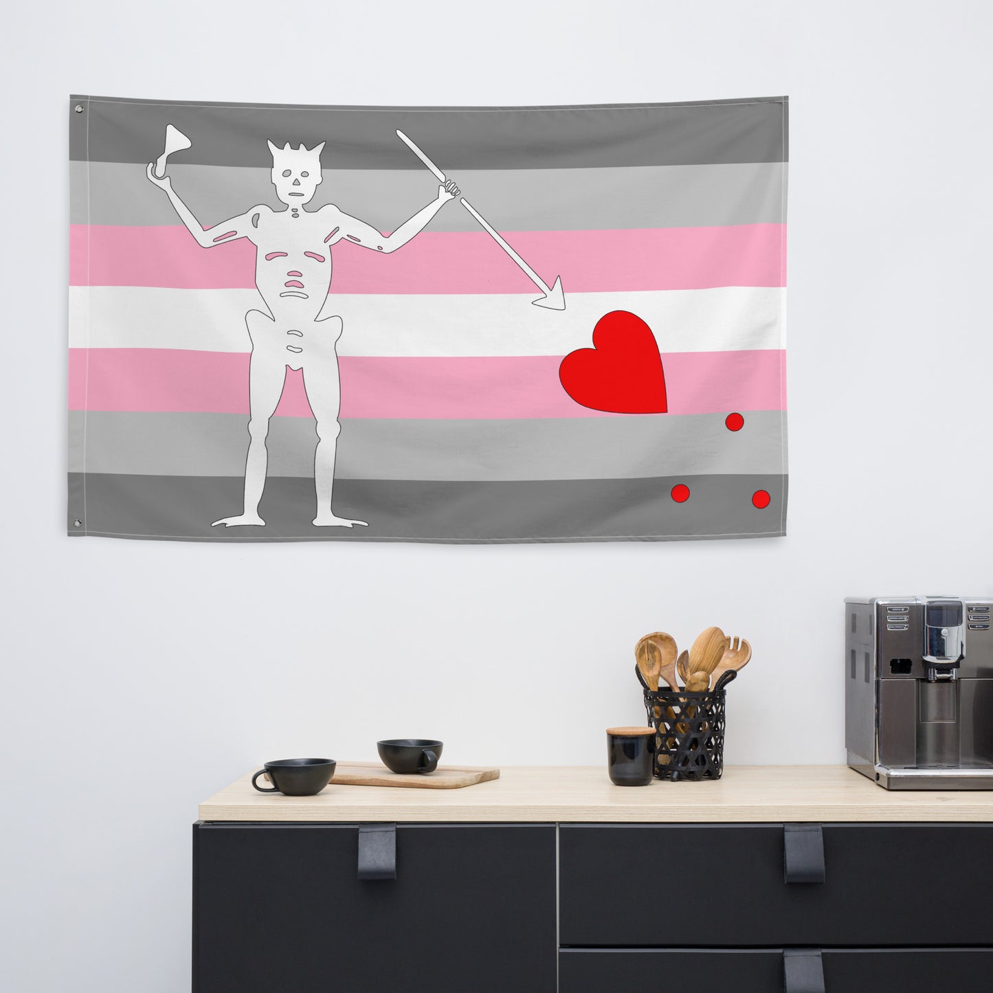 the demigirl blackbeard pirate flag hanging on a white wall in a kitchen above the counter