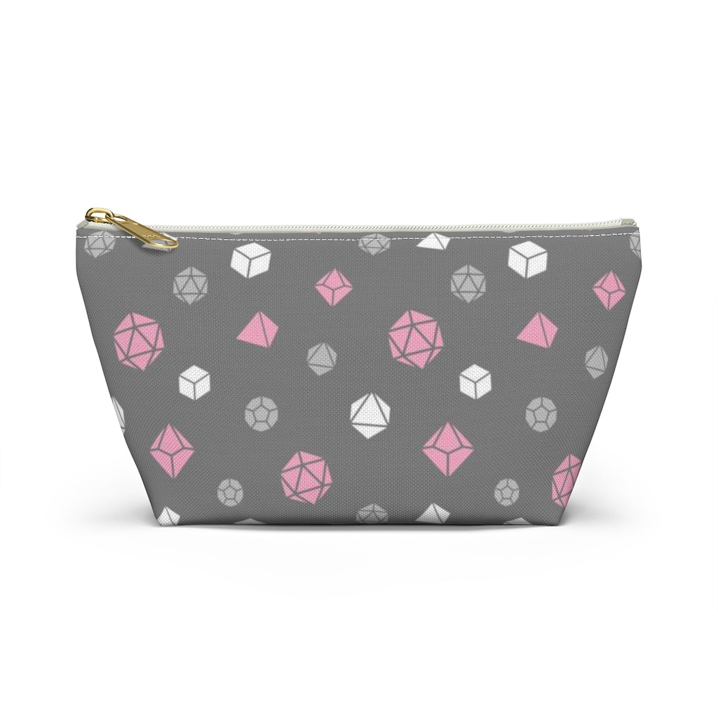 the small demigirl dice t-bottom pouch in front view on a white background. it's dark grey with light grey, white, and pink polyhedral dice and a gold zipper pull