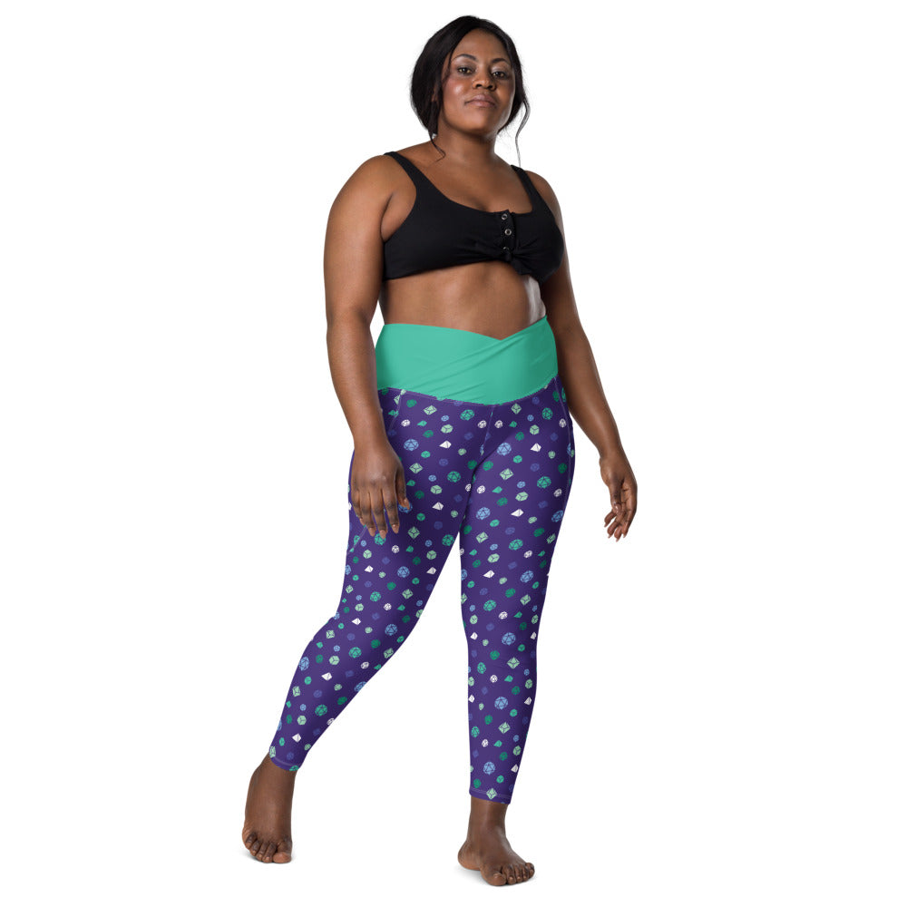 front view of dark-skinned female-presenting plus size model wearing gay mlm dice leggings and a black sports bra. This view shows off the green crossover high-rise waistband