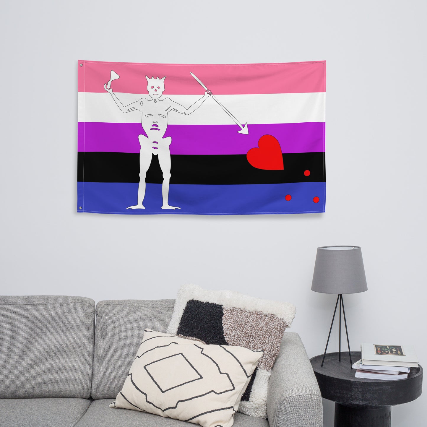 the genderfluid blackbeard pirate flag hanging in a living room above a couch and side table