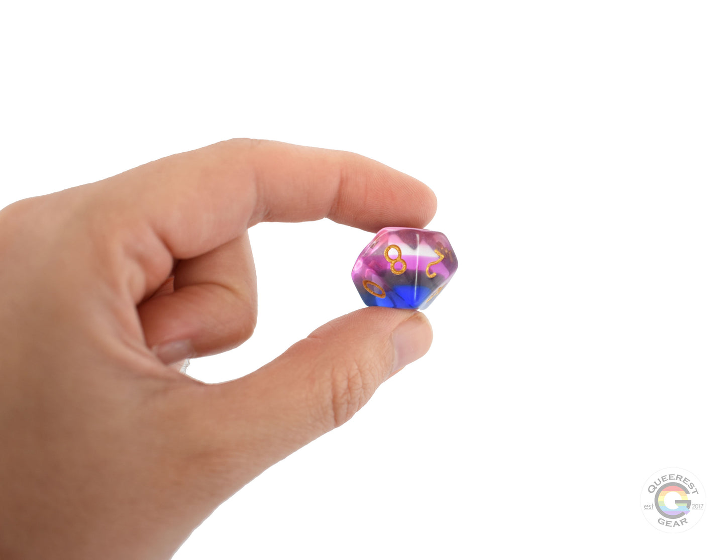 A hand holding up the genderfluid d10 to show off the color and transparency