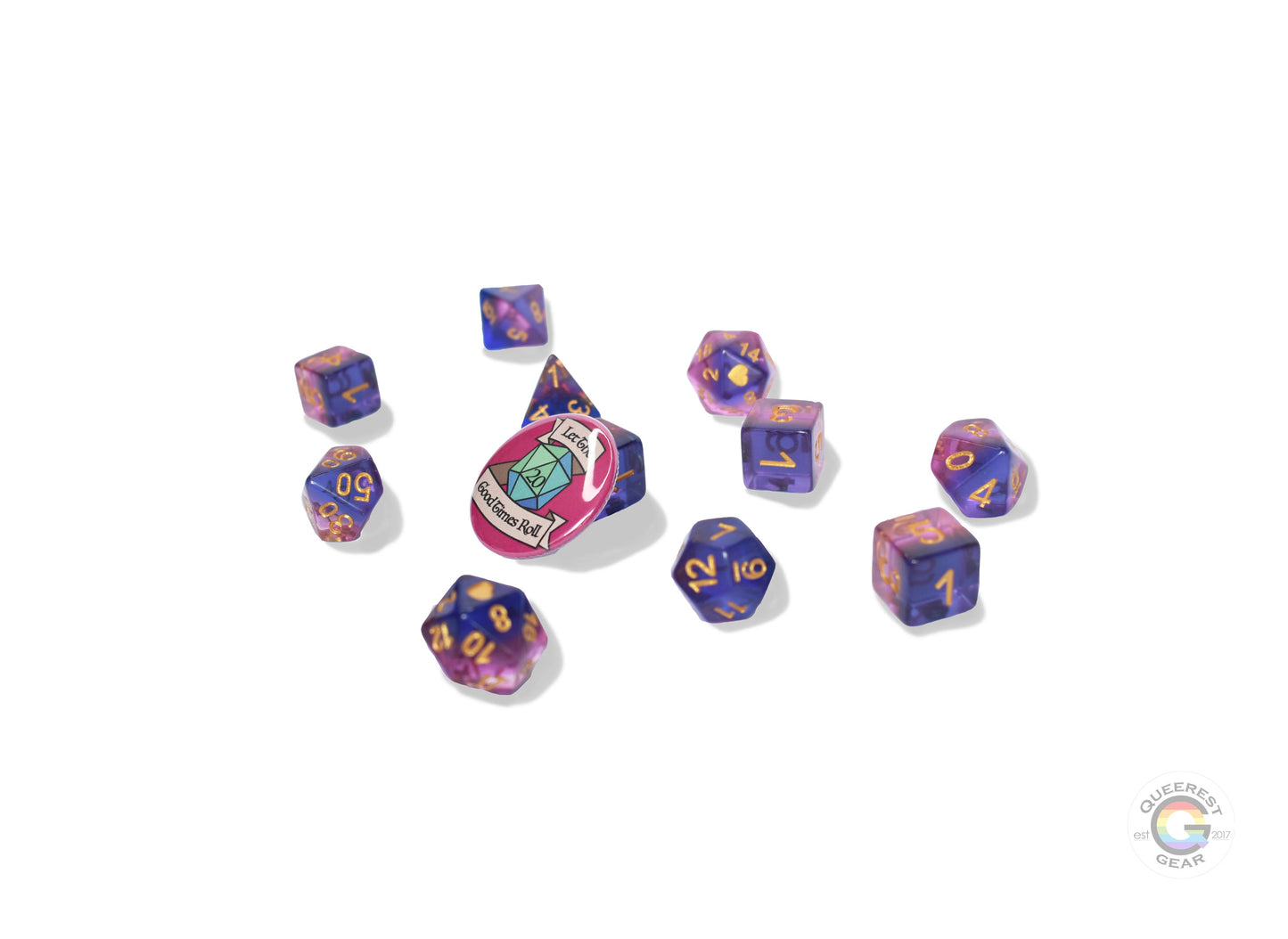 11 piece set of polyhedral dice scattered on a white background. They are transparent and colored in the stripes of the genderfluid flag with gold ink. There is the freebie “let the good times roll” pinback button among them.