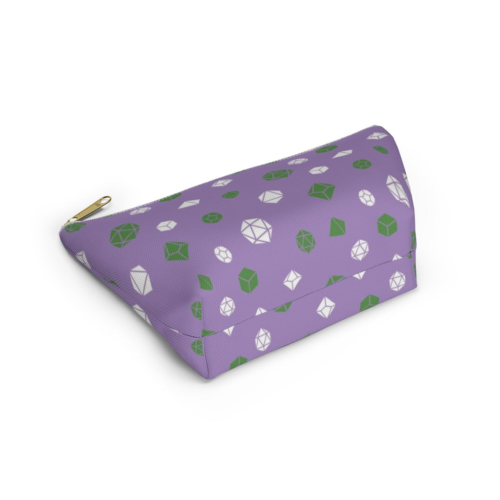 the small genderqueer dice t-bottom pouch in bottom view on a white background. it's purple with green and white polyhedral dice and a gold zipper pull