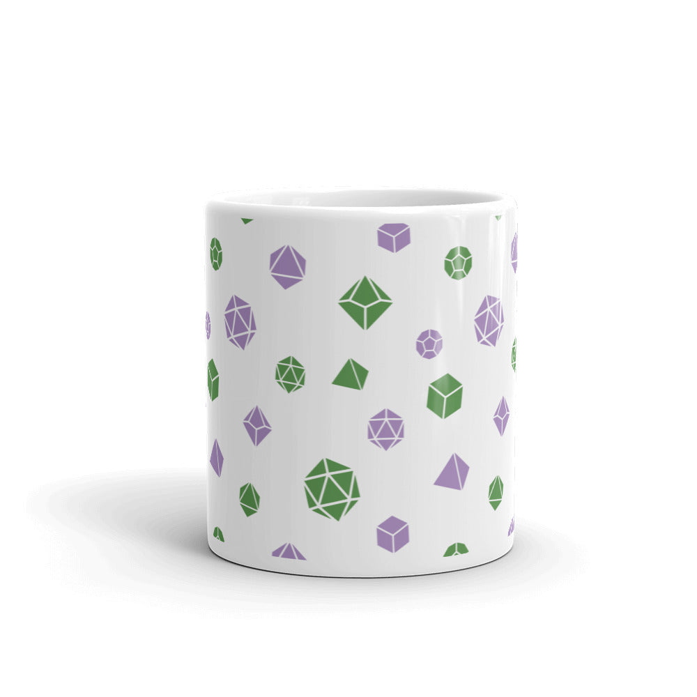 white mug on a white background with handle facing back. It has an all-over print of polyhedral d&d dice in the genderqueer colors of green and purple