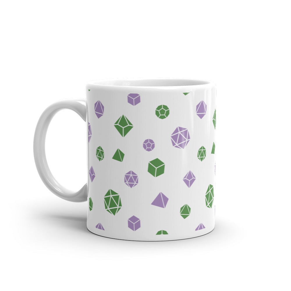 white mug on a white background with handle facing left. It has an all-over print of polyhedral d&d dice in the genderqueer colors of green and purple