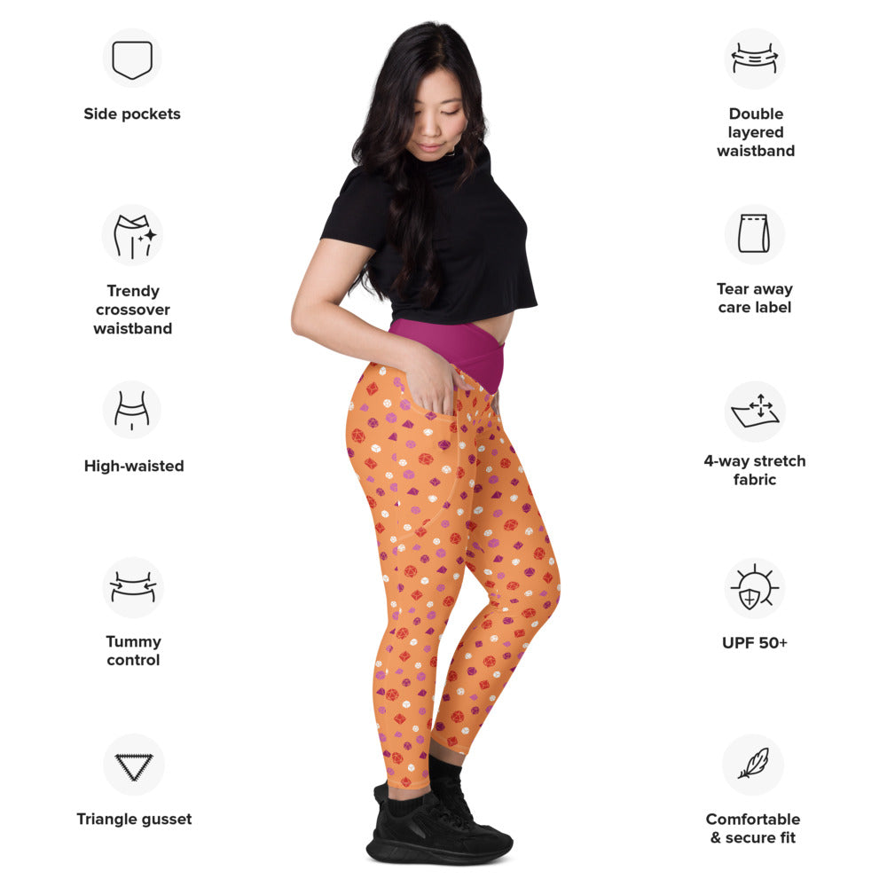 Light-skinned dark-haired female-presenting model wearing the lesbian dice leggings. she is facing right and has a hand in the pocket. she is surrounded by product specs: "side pockets, trendy crossover waistband, high-waisted, tummy control, triangle gusset, double layered waistband, tear away care label, 4-way stretch fabric, UPF 50+, comfortable & secure fit"