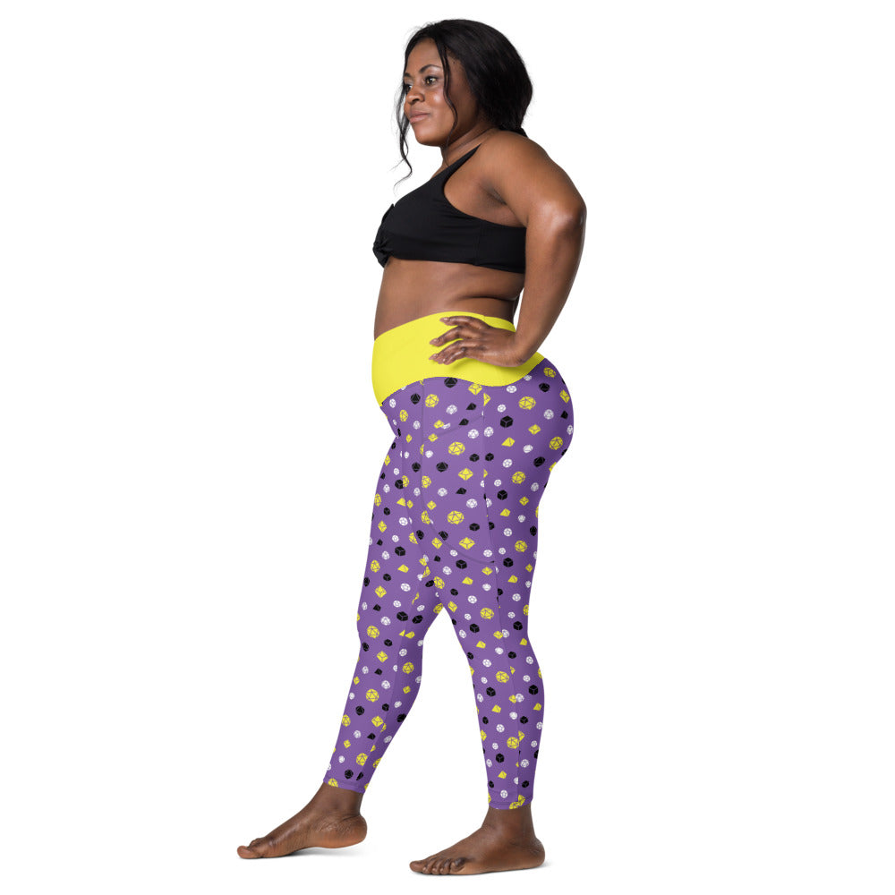 Left side view of dark-skinned female-presenting plus size model wearing the nonbinary dice leggings and black sports bra. She is facing left with her left hand on her hip and right leg forward