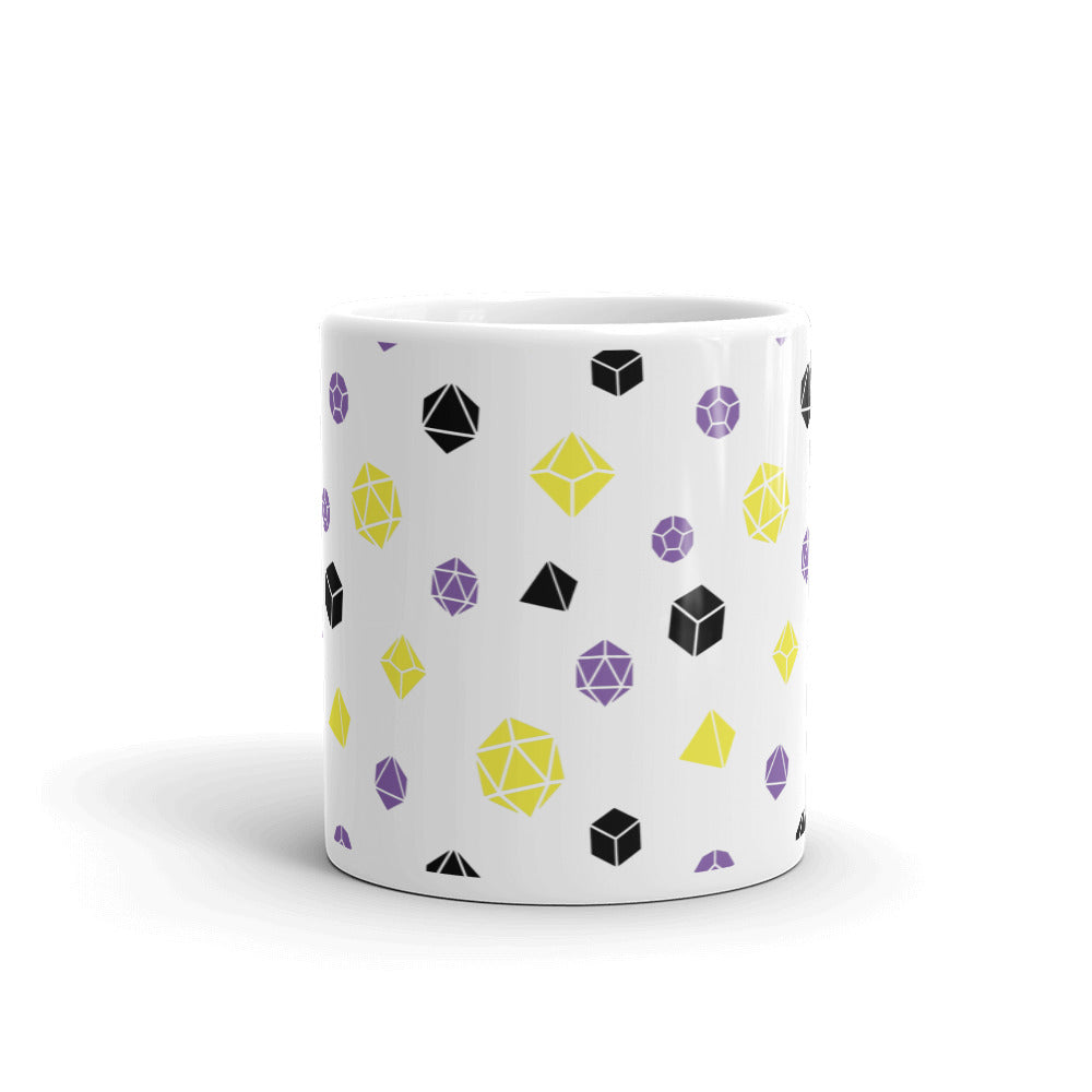 white mug on a white background with handle facing back. It has an all-over print of polyhedral d&d dice in the nonbinary colors of yellow, black, and purple