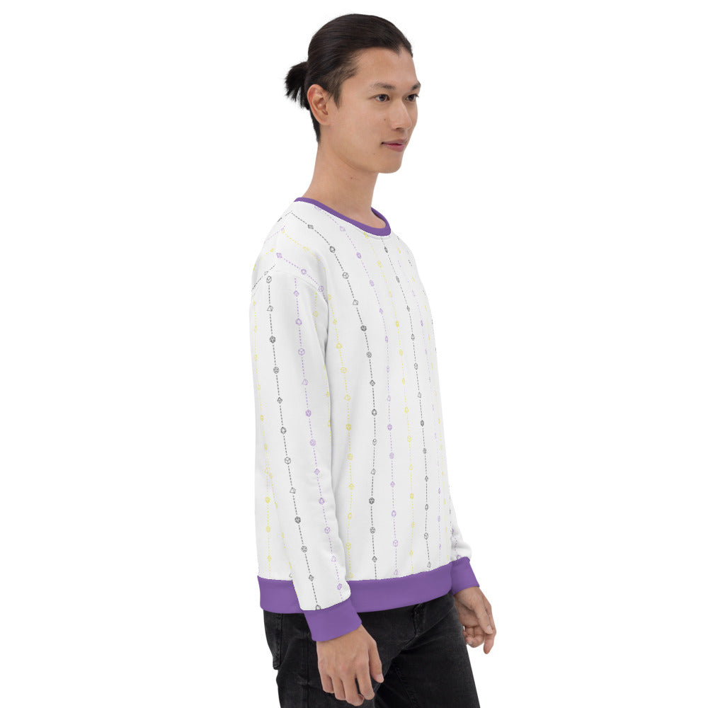 light-skinned dark haired model on a white background facing right wearing the nonbinary pride dice sweater