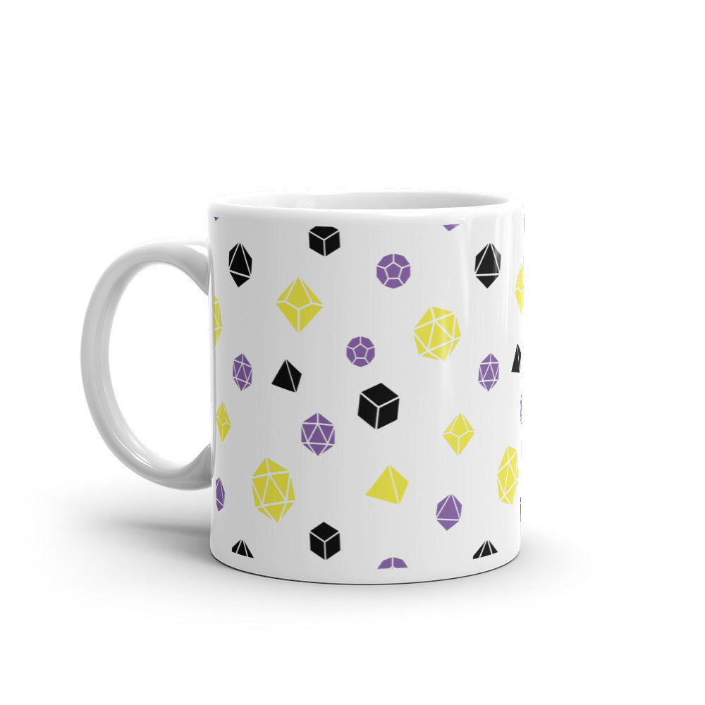 white mug on a white background with handle facing left. It has an all-over print of polyhedral d&d dice in the nonbinary colors of yellow, purple, and black