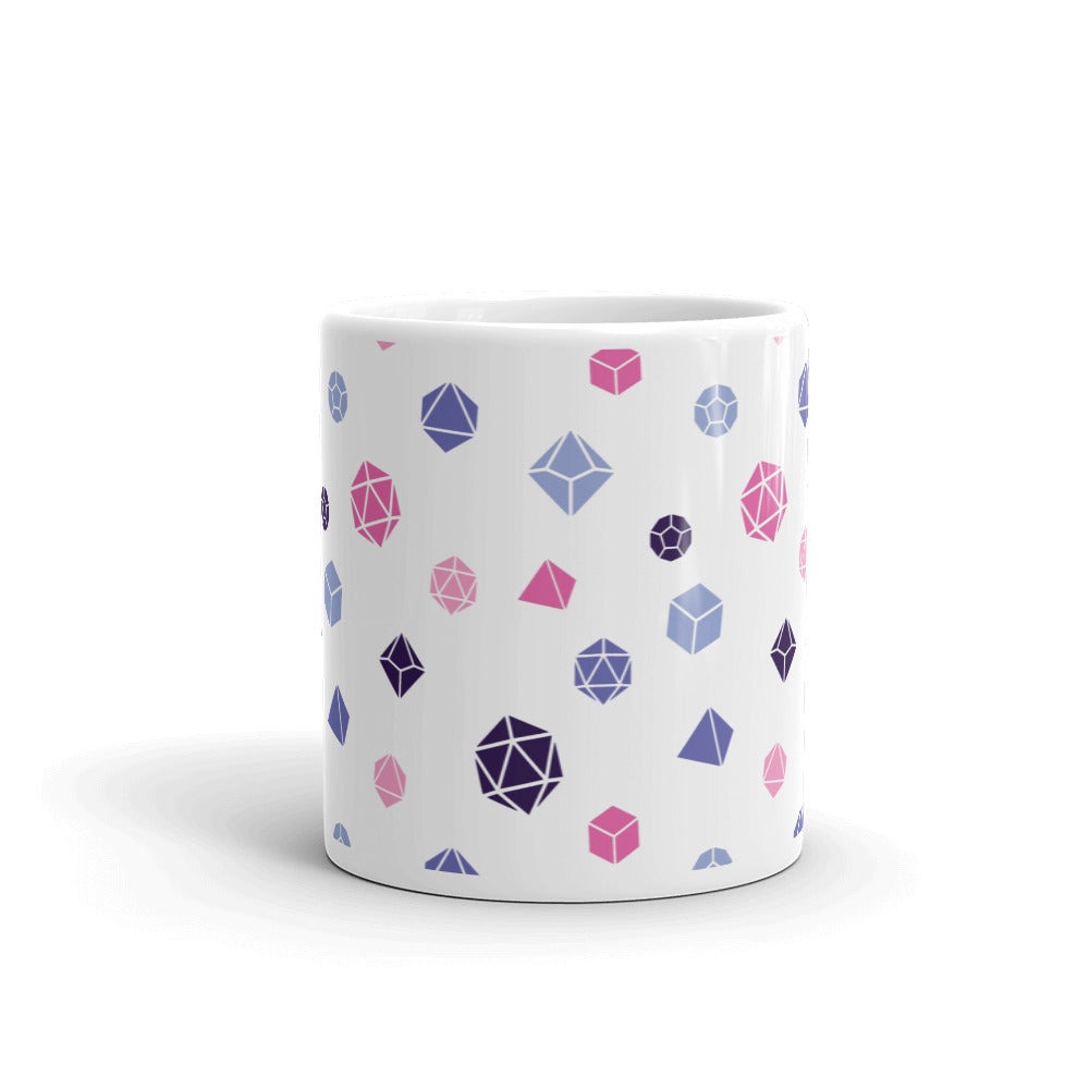 white mug on a white background with handle facing back. It has an all-over print of polyhedral d&d dice in the omnisexual colors of pinks, blues, and dark purple