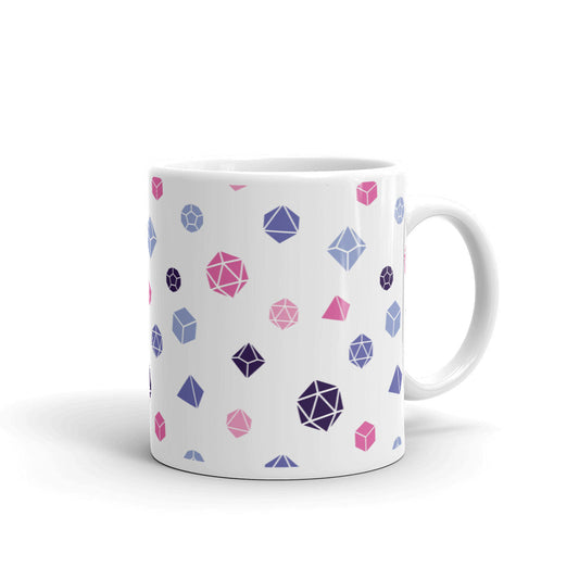 white mug on a white background with handle facing right. It has an all-over print of polyhedral d&d dice in the omnisexual colors of blues, pinks, and dark purple