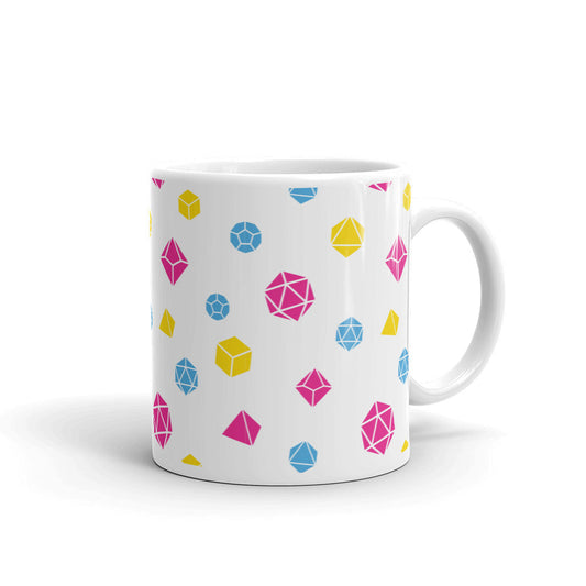 white mug on a white background with handle facing right. It has an all-over print of polyhedral d&d dice in the pansexual colors of pink, blue, and yellow