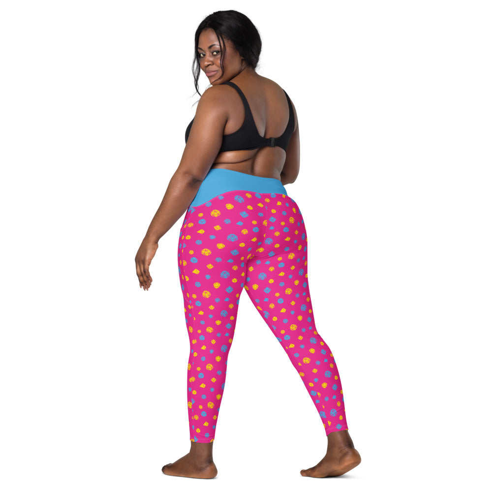 back view of dark-skinned female-presenting model looking over her shoulder. She is wearing the pansexual dice leggings and a black sports bra