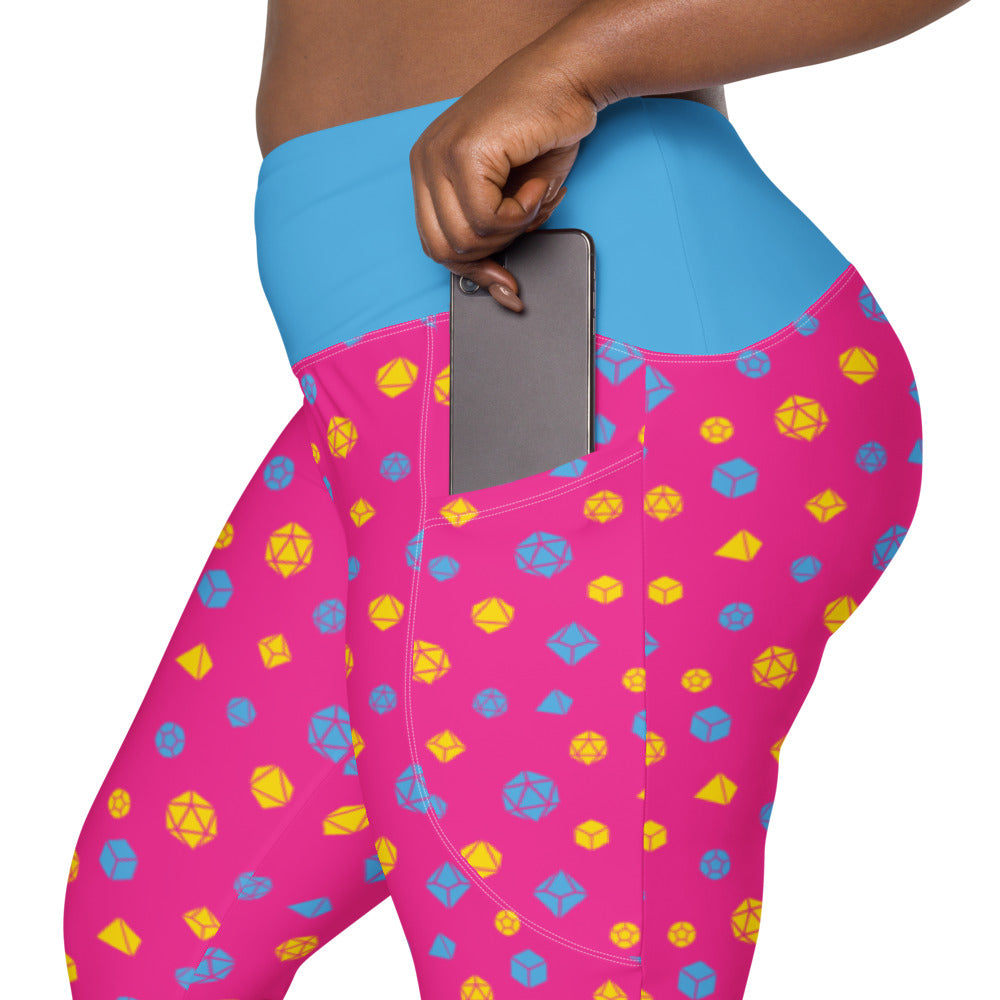 left side view of pansexual dnd dice plus size leggings. the dark-skinned female-presenting model is sliding her phone into one of the side pockets