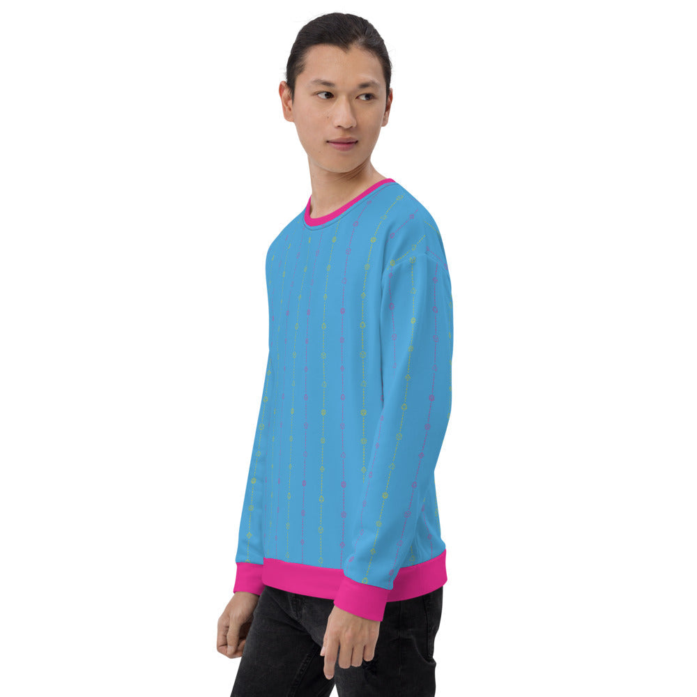 light-skinned dark haired model on a white background facing left wearing the pansexual pride dice sweater