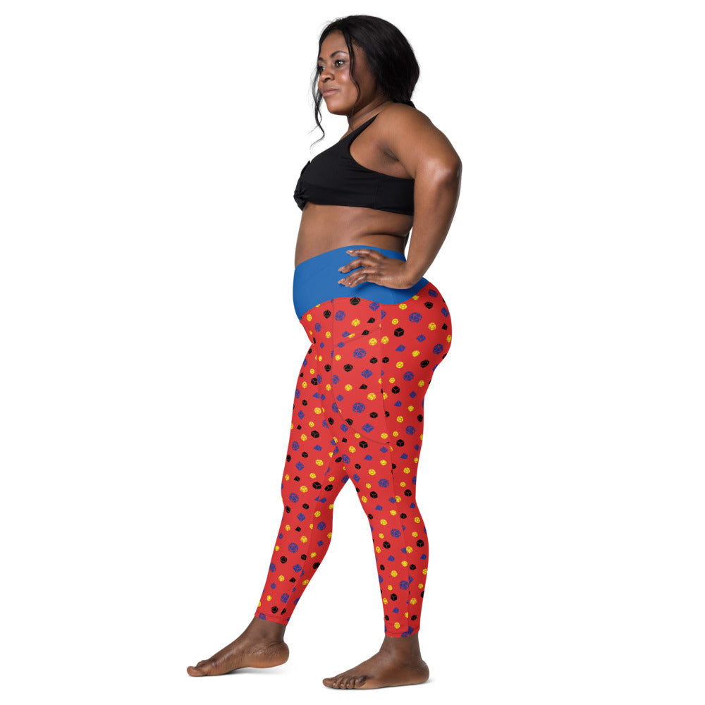Left side view of dark-skinned female-presenting model wearing the polyamory dice leggings and black sports bra. She is facing left with her left hand on her hip and right leg forward