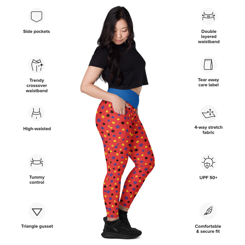 Light-skinned dark-haired female-presenting model wearing polyamory dice leggings. she is facing right and has a hand in the pocket. she is surrounded by product specs: "side pockets, trendy crossover waistband, high-waisted, tummy control, triangle gusset, double layered waistband, tear away care label, 4-way stretch fabric, UPF 50+, comfortable & secure fi