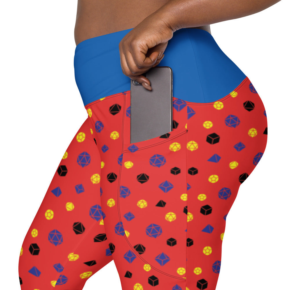 left side view of polyamory dnd dice plus size leggings. the dark-skinned female-presenting model is sliding her phone into one of the side pockets
