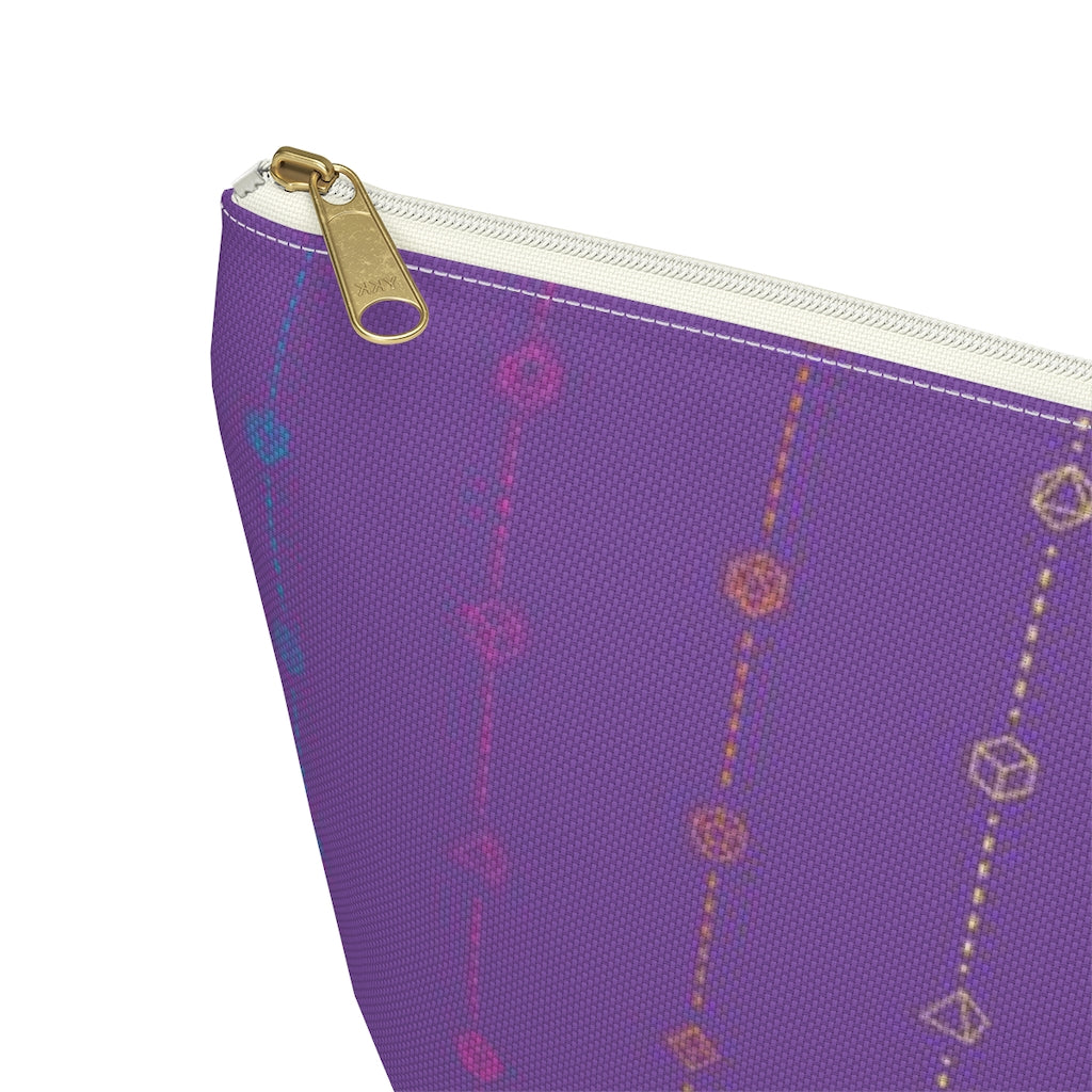 the large rainbow dice t-bottom pouch corner detail on a white background. it's purple with pink, orange, yellow, green, and blue stripes of dashed lines and polyhedral dice and a gold zipper pull