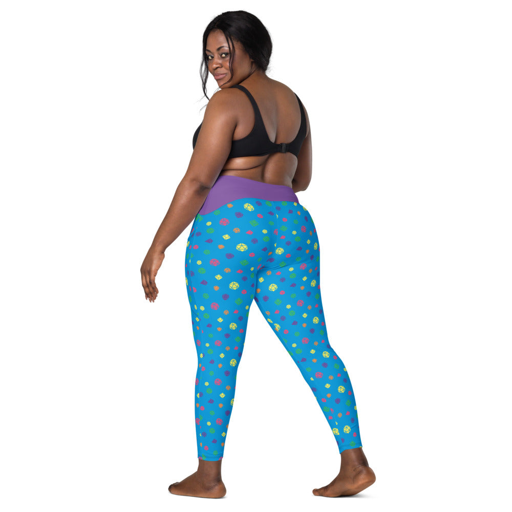 back view of dark-skinned female-presenting model looking over her shoulder. She is wearing the rainbow dice leggings and a black sports bra