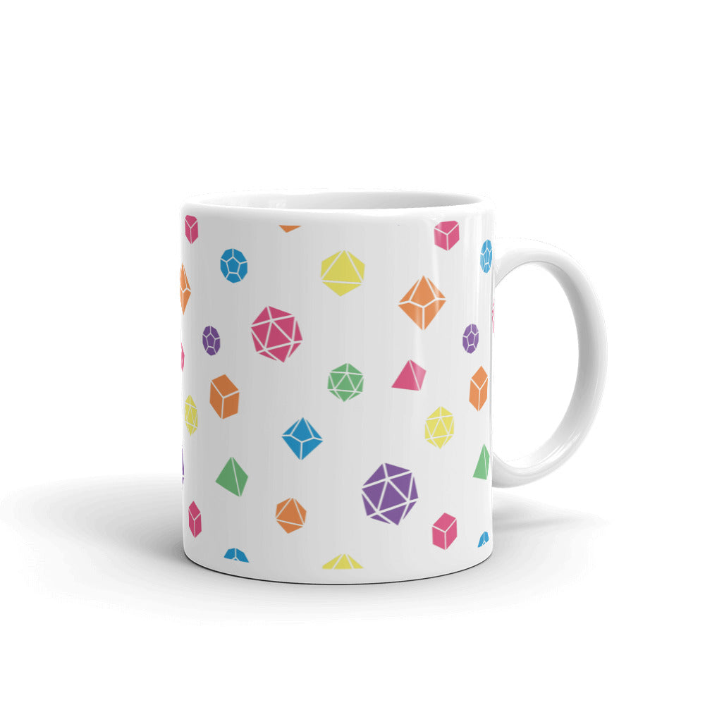 white mug on a white background with handle facing right. It has an all-over print of polyhedral d&d dice in rainbow colors