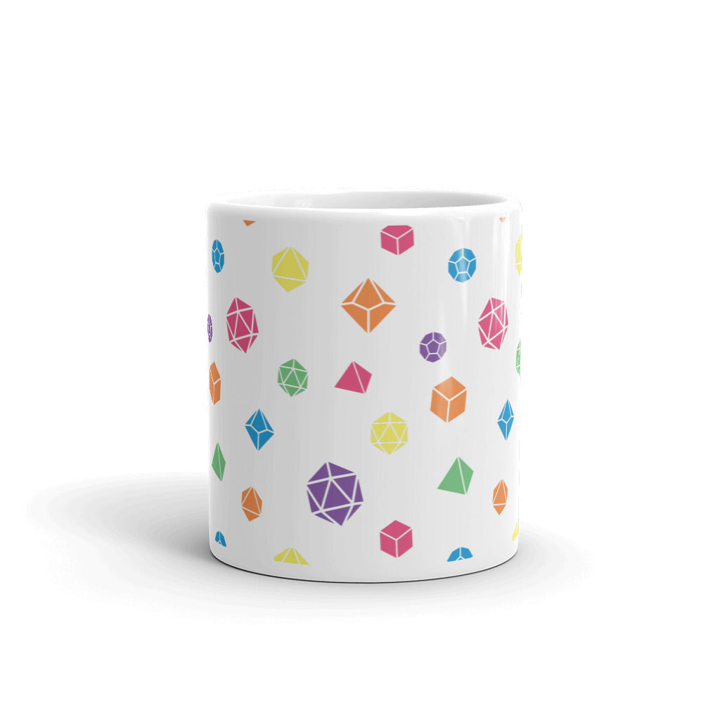 white mug on a white background with handle facing back. It has an all-over print of polyhedral d&d dice in rainbow colors