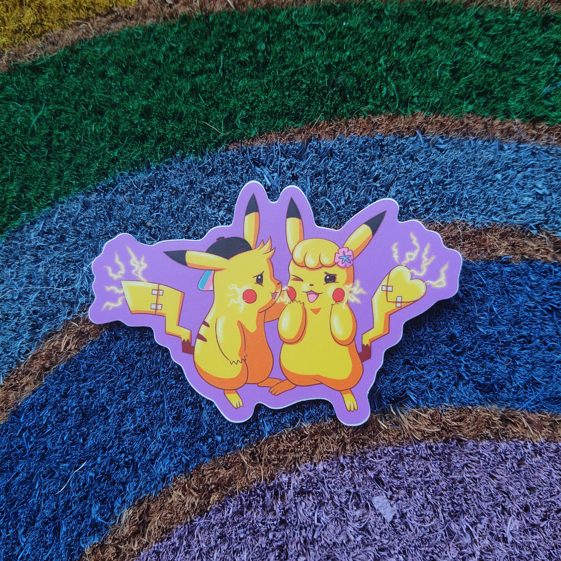 the trans for trans sticker on a rough rainbow background. the sticker is a pair of transgender animals with electric current flowing and a purple outline