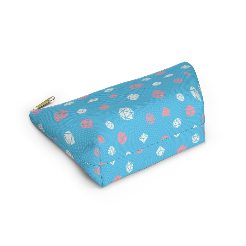 the small trans dice t-bottom pouch showing the T-bottom on a white background. it's blue with pink and white polyhedral dice and a gold zipper pull