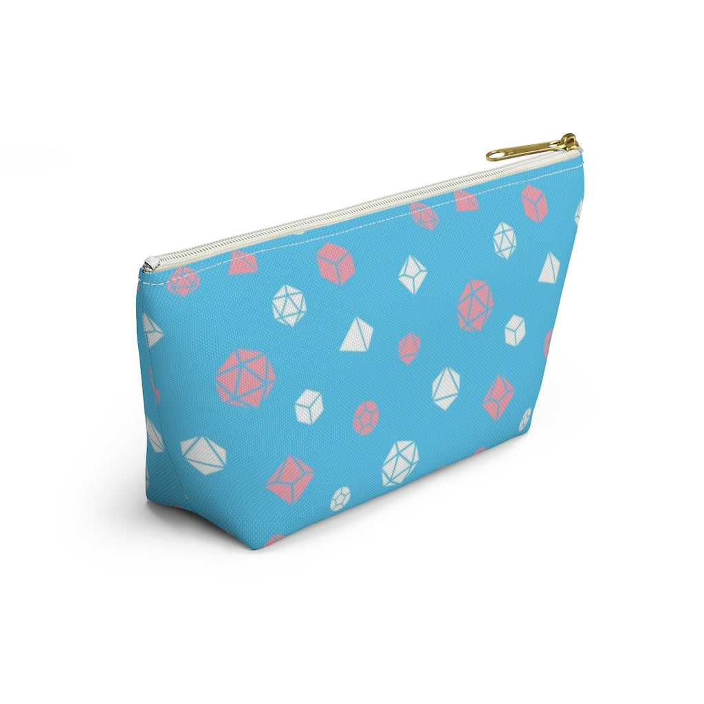 the small trans dice t-bottom pouch from the side on a white background. it's blue with pink and white polyhedral dice and a gold zipper pull